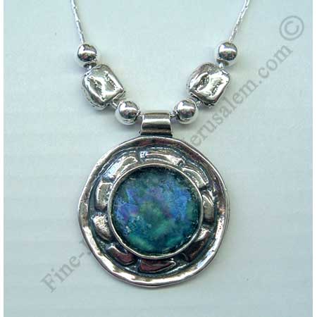 abstract design in sterling slver smaller round pendant set with Roman glass