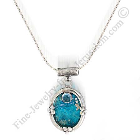 beautiful sterling silver pendant with synthetic blue topaz set on Roman glass